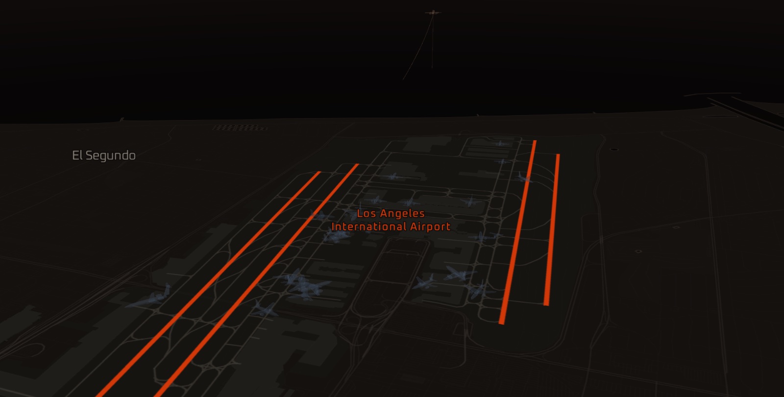 Los Angeles International from the east, pitched, its four runways lit in the accent and aircraft on the aprons